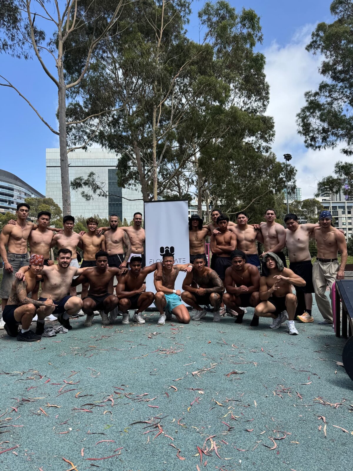 Flowstate brotherhood members posing with the Flowstate banner