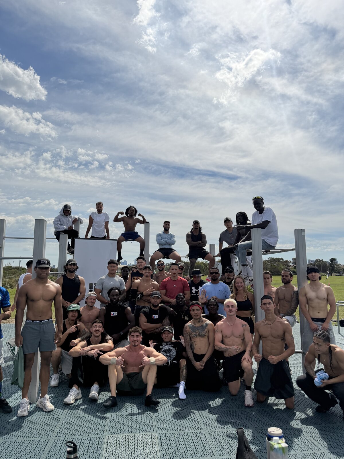 Large Flowstate brotherhood group photo at an outdoor calisthenics park